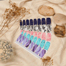 a set of nail stickers with purple and blue designs on them