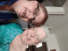 two women wearing glasses are smiling for a photo