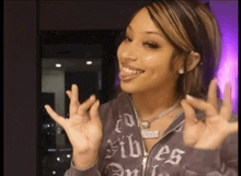 a woman wearing a hoodie that says vibe on it