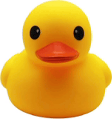 a yellow rubber duck with black eyes is sitting on a white surface .