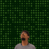 a man stands in front of a green background with the number 31