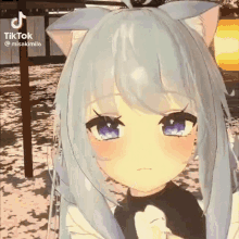 a girl with white hair and cat ears is standing in front of a building .