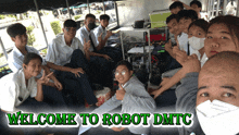 a group of young people are sitting under a tent with the words welcome to robot dmtc on the bottom