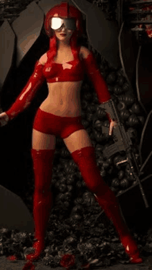 a woman in a red costume is holding a gun and standing in front of a pile of skulls .