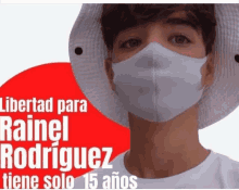 a man wearing a white face mask with the words libertad para rainel rodriguez on it