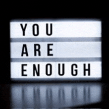 a light box that says `` you are enough '' on it .