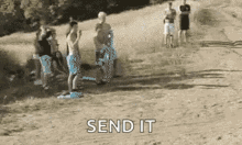 a group of people standing on top of a dirt field with the words send it written on the bottom