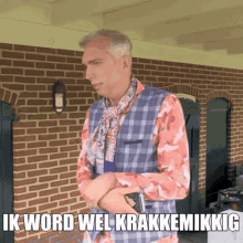 a man standing in front of a brick building with the words ik word wel krakkemikkig on the bottom