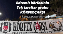 a banner that says korfez carsi is hanging in front of a building