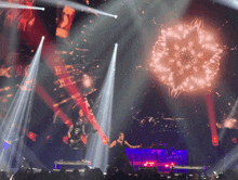 a man playing a guitar on a stage with a crowd watching