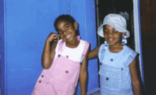 two little girls are standing next to each other and smiling for the camera