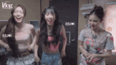 three girls are dancing in a room with the words ilog in the background