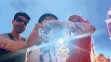 a group of people are standing in front of a ferris wheel and making a heart shape with their hands .