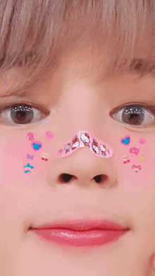 a close up of a person 's face with stickers on it