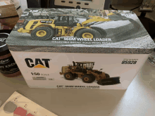 a cat 966m wheel loader is in a box on a table