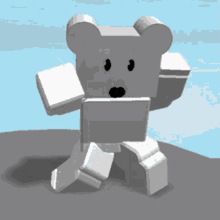 a white teddy bear is standing on a rock