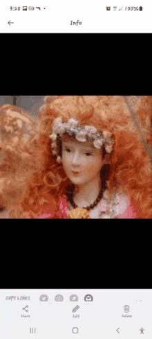 a doll with red hair and flowers in her hair