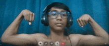 a man wearing headphones and glasses flexes his muscles in a video call