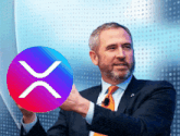a man in a suit and tie holds up a purple and red circle with a white x on it