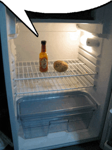 an open refrigerator with a bottle of hot sauce on the shelf