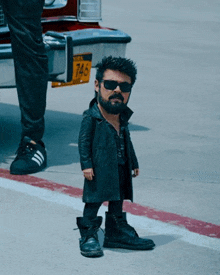 a man with a beard and sunglasses is standing next to a car with a new york license plate number of 746