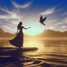 a woman in a long dress is standing on the shore of a lake with a bird flying overhead