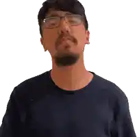 a man with a beard wearing glasses and a blue shirt