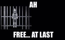 a statue of a man jumping out of a jail cell with the words ah free at last