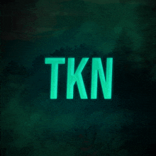 the word tkn is glowing brightly in the dark