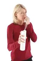 a woman in a red sweater is holding a spray bottle