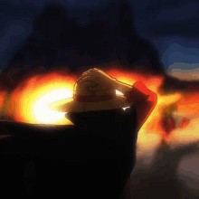 a person wearing a straw hat with the letter r on it stands in front of a fire