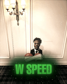 a man in a suit and tie is sitting in a box with the words w speed written below him