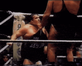a man in a boxing ring with a sign on the wall that says ' sd '