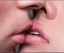 a man and a woman are kissing with pink lipstick on their lips