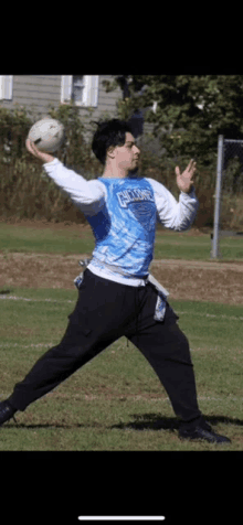 a man wearing a shirt that says carlsbad is throwing a ball