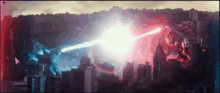 a giant monster is fighting another monster in a city with a red and blue light coming out of it 's mouth .