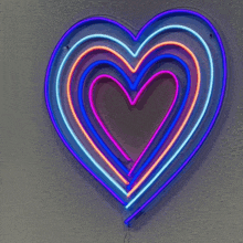 a neon sign in the shape of a heart is lit up