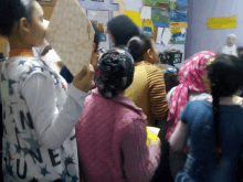 a woman holding a piece of paper with rune written on it