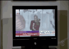 a tv screen shows holly ellenbogen on the news channel