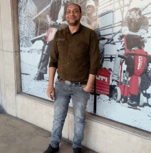 a smiling man stands in front of a wall with a hilti logo