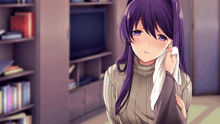 a girl with purple hair wipes her face with a cloth