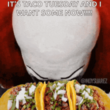 a picture of a person eating tacos that says it 's taco tuesday and i want some now !!!