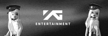 a black and white photo of two dolls in front of an entertainment logo