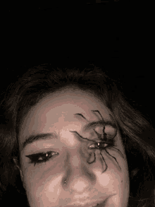 a woman has a spider painted on her forehead