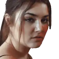 a close up of a woman 's face with her hair in a ponytail