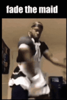 a man is dressed as a maid and dancing .