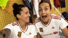 two female soccer players are posing for a picture in a locker room with the words ya estamos por hay on the bottom