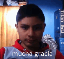 a young boy with the word mucha gracia written on his shirt