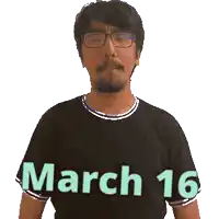 a man wearing glasses and a black shirt with march 16 written on it