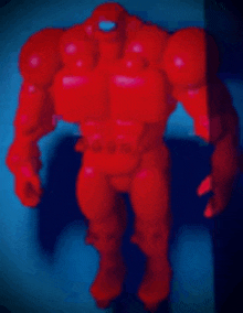 a red robot with a blue background is standing in the dark